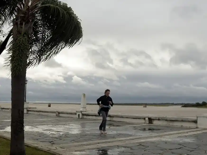 Contra viento, una vecina caminando de cara al sur a caminar por la Costanera, con las intensas ráfagas de viento. Guillermo Di Salvatore.